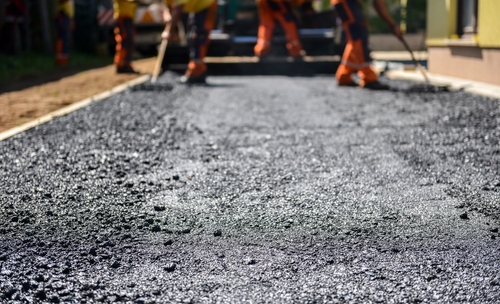 Team,of,workers,making,and,constructing,asphalt,road,construction,with